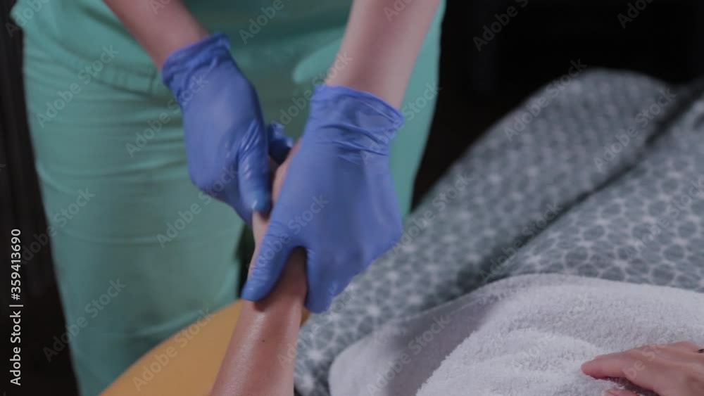 Professional beautician does hand massage to woman. Professional beautician does hand massage to woman.