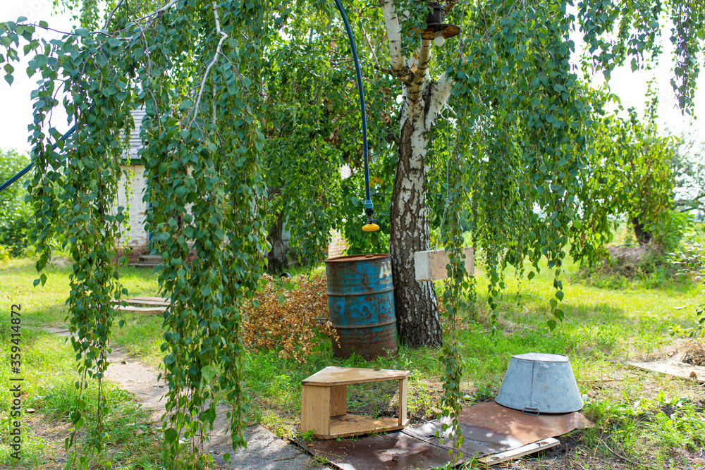 Outdoor shower in the village. Hose with tap and diffuser in the open air Outdoor shower in the village. Hose with tap and diffuser in the open air