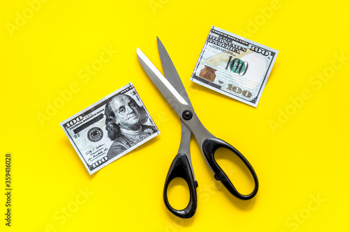 Cutting of US dollar banknote. Economic crisis concept