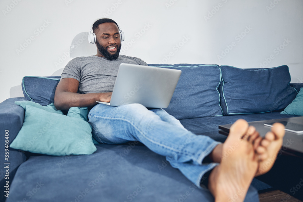 Joyful young male person playing games online