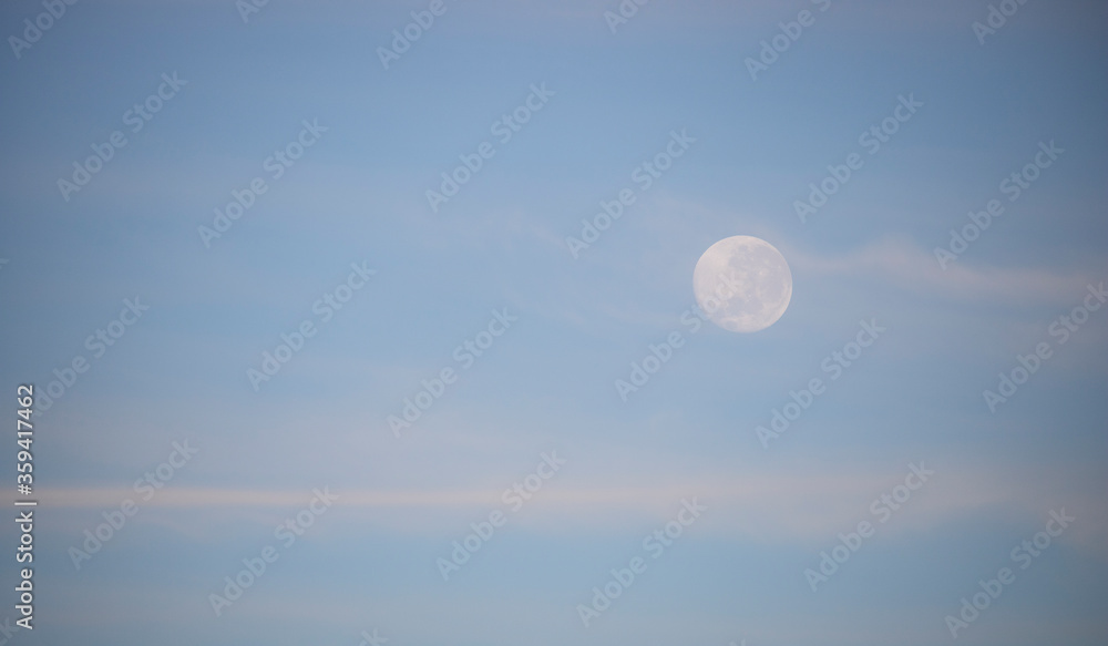 Beautiful view close up of a full moon at sunrise or sunset. Beautiful view close up of a full moon at sunrise or sunset.