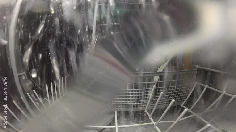 Slow motion. The master repairs the dishwasher and checks the operation