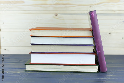 Education and reading concept - group of colorful books on the wooden table.