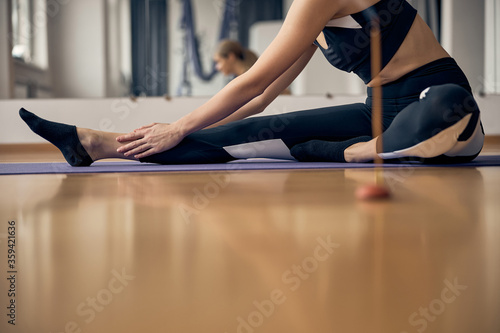 Woman in sportswear exercising with aroma sticks