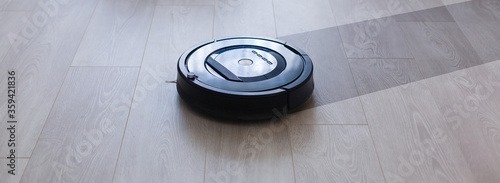 Obraz na plátně robotic vacuum cleaner on laminate wood floor smart cleaning technology