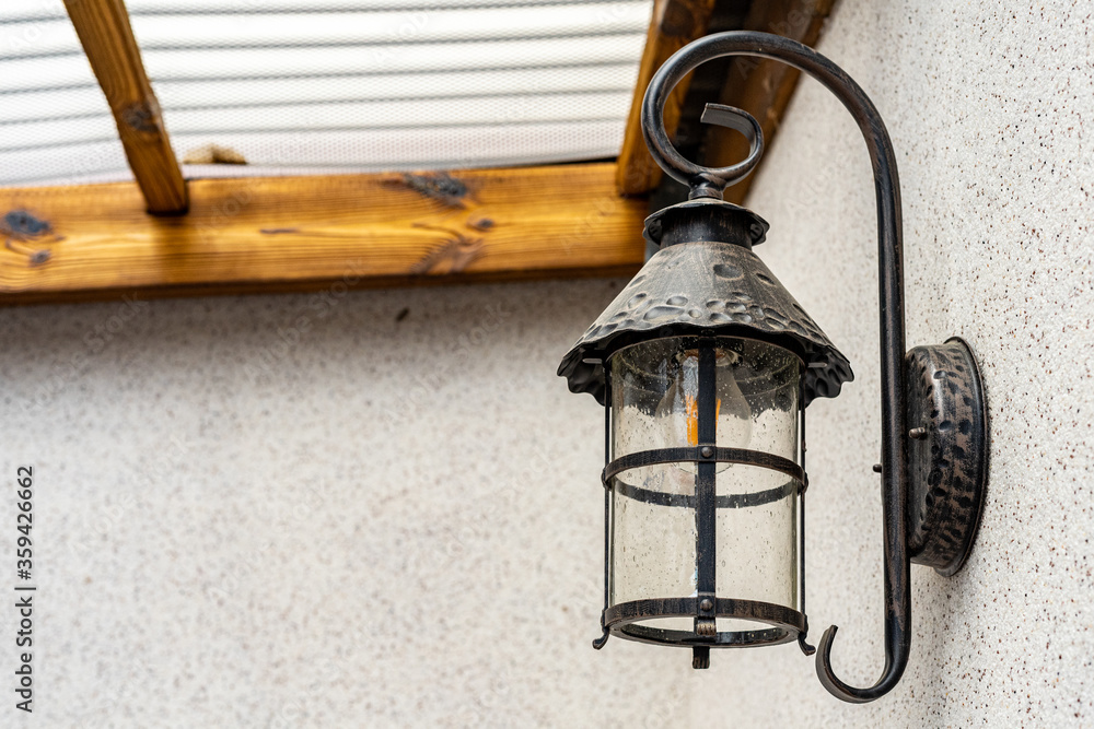 Lamp in vintage style. The lamp is attached to the wall. The lamp is black