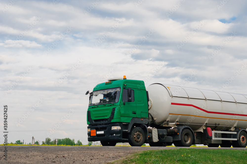 Obraz premium Truck with container on highway, cargo transportation concept. Shaving effect.