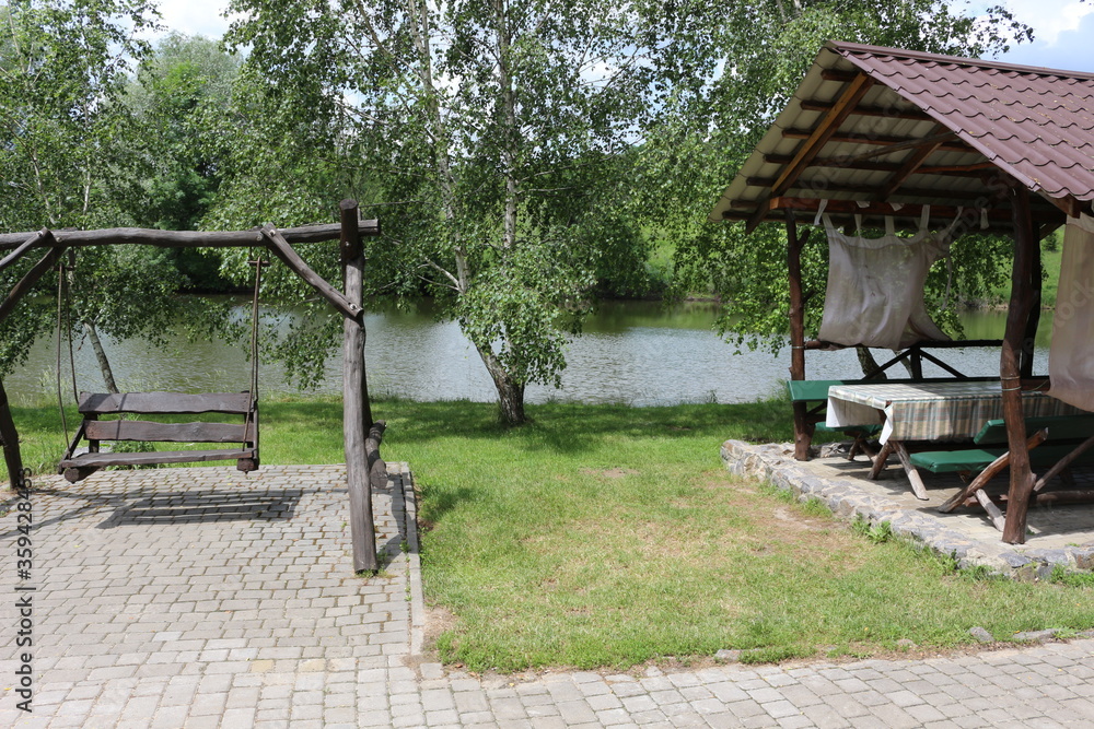 The recreation center in ethno style is a favorite vacation spot in Ukraine. Children and adults love to ride wooden swings.