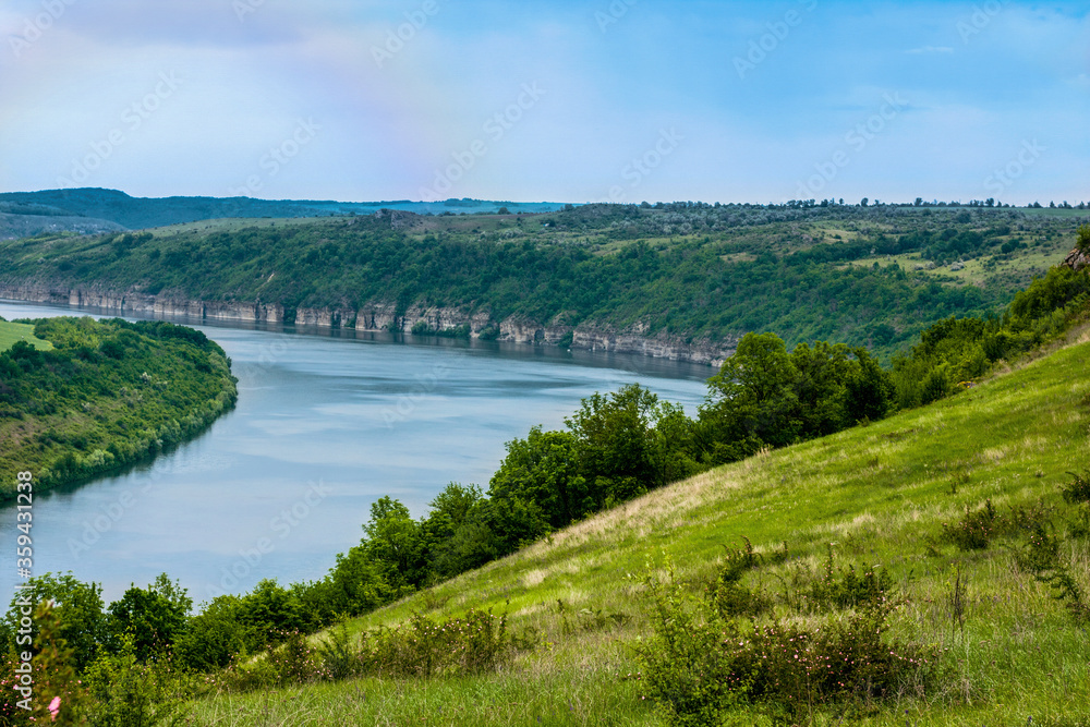 Colorful landscape with high Ukrainian mountains, beautiful river, green forest, rainbow. Mountain river. Travel in Ukraine
