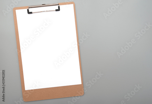 Paper clipboard with clean white blank paper for text, ideas on gray background, top view 