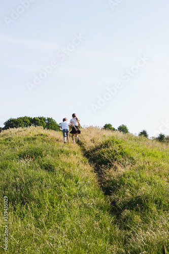 running children in the field in early summer morning © Yuliia Kos