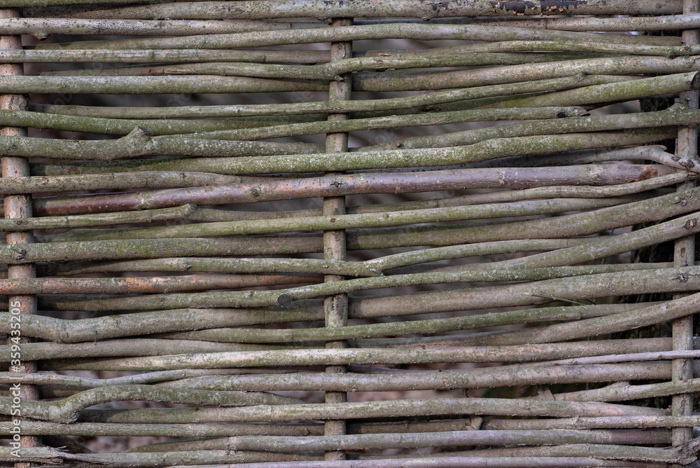 Woven wood fence in village or country house. Rustic style Woven wood fence in village or country house. Rustic style