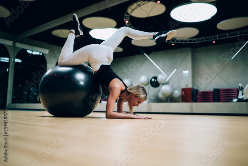 Slim woman training with gymnastic ball