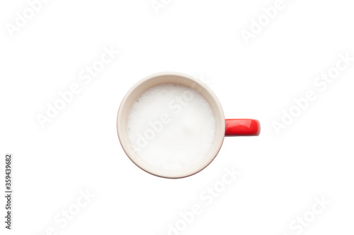 A retro cup with coffee cream. Food art creative concept image  cute drawing with cinnamon powder over milk cream on a white background.