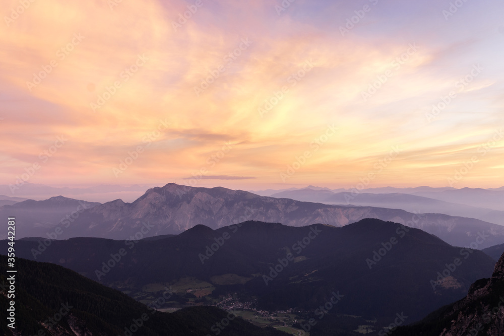 Mountain landscape at sunset in Julian Alps. Amazing view on colorful clouds and layered mountains silhouettes. Mountain landscape at sunset in Julian Alps. Amazing view on colorful clouds and layered mountains silhouettes.