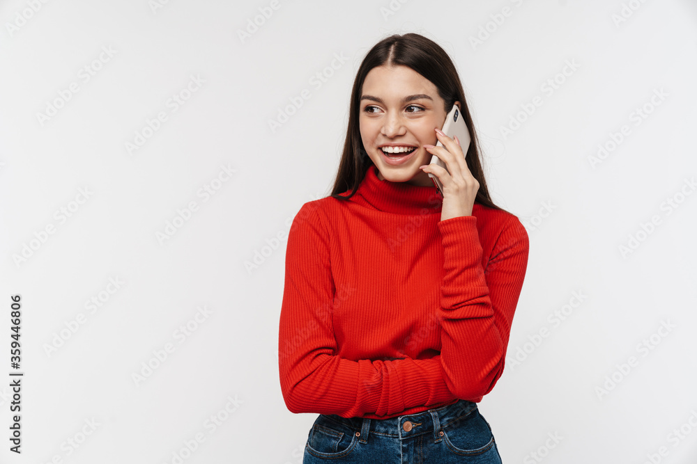 Photo of happy young woman smiling while talking on mobile phone Photo of happy young woman smiling while talking on mobile phone
