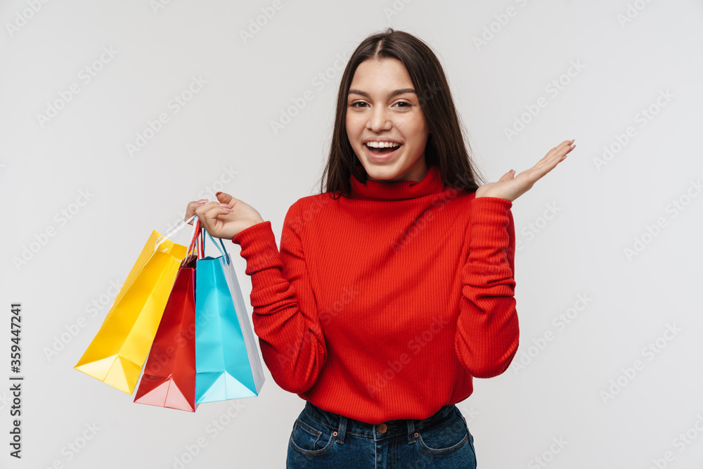 Photo of excited brunette woman holding copyspace and shopping bags Photo of excited brunette woman holding copyspace and shopping bags