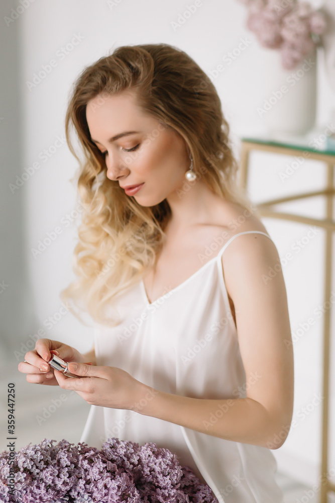Naklejka premium Portrait of female model girl opens female perfume for a tasty smell