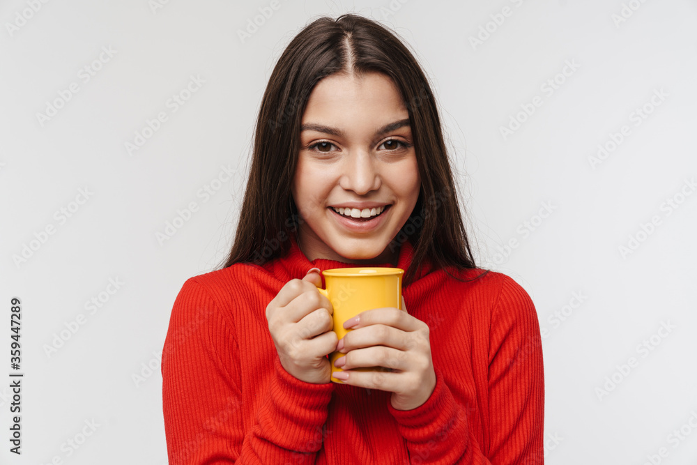 Photo of cheerful brunette woman laughing and holding cup Photo of cheerful brunette woman laughing and holding cup
