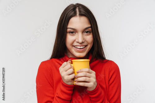 Photo of cheerful brunette woman laughing and holding cup