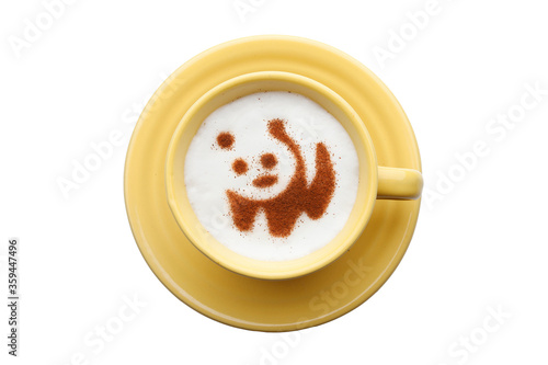 A rustic mug with coffee cream. Food art creative concept image, drawing with cinnamon powder over cream in a white background. 