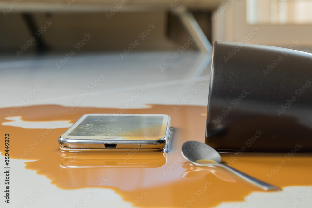 The smartphone fall on the floor and broken with coffee spilled
The smartphone fall on the floor and broken with coffee spilled