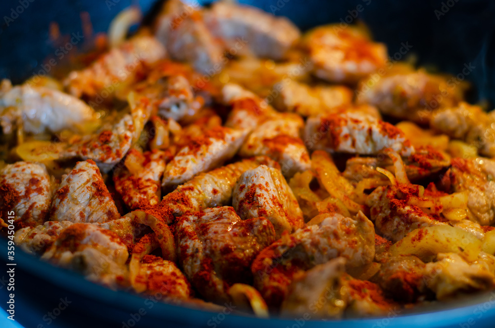Sliced meat fried in a pan. Sliced meat fried in a pan.