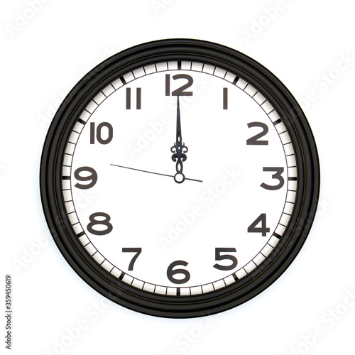 Black round analog wall clock isolated on white background, its twelve oclock.