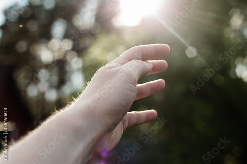 play with hand on the background of the sun