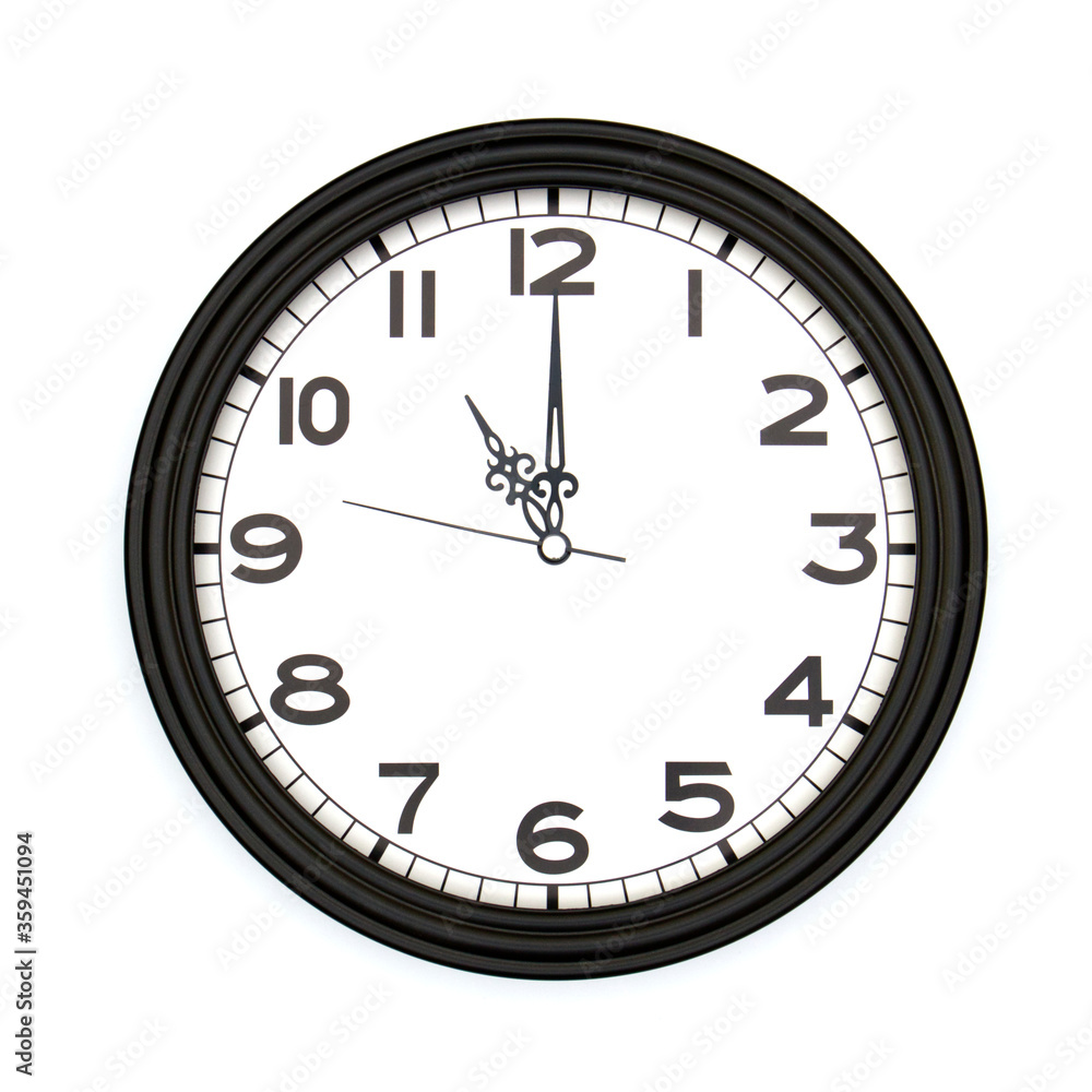 Black round analog wall clock isolated on white background, its eleven oclock. Black round analog wall clock isolated on white background, its eleven oclock.