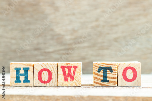 Alphabet letter in word how to on wood background photo