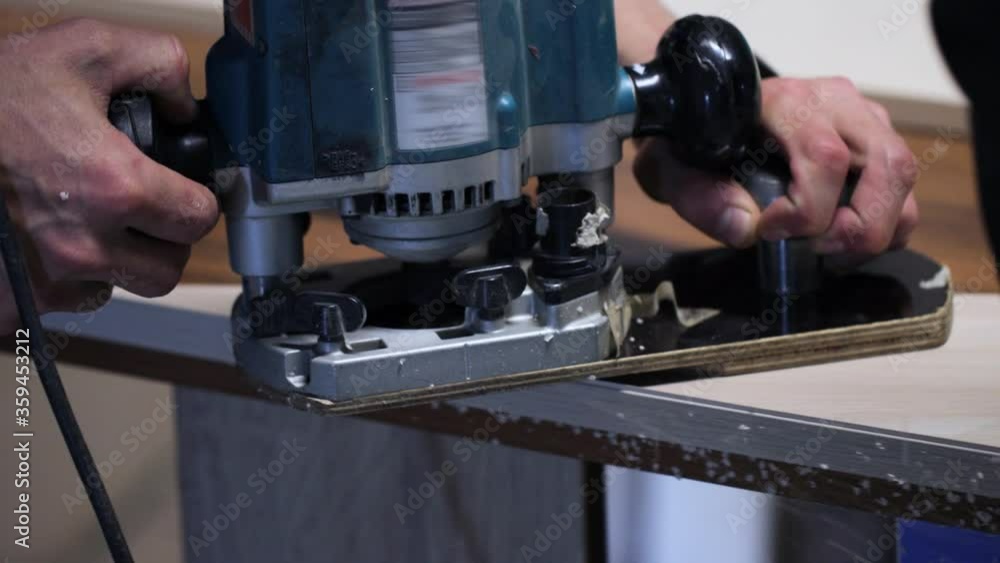 Craftsman working with handheld router