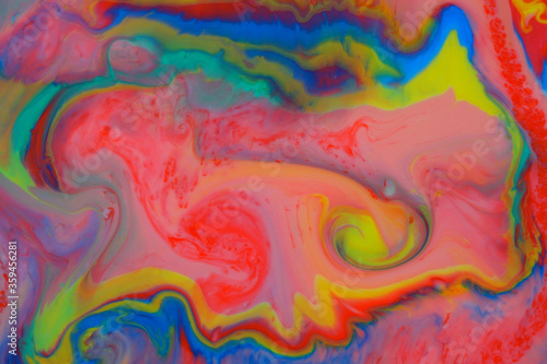 Abstract psychedelic background. Movement of ink in a multicolored liquid