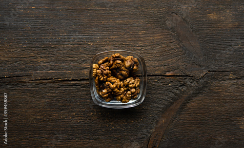 Walnut in a small plate on a vintage wooden table. Walnuts is a healthy vegetarian protein nutritious food. Natural nuts snacks.
