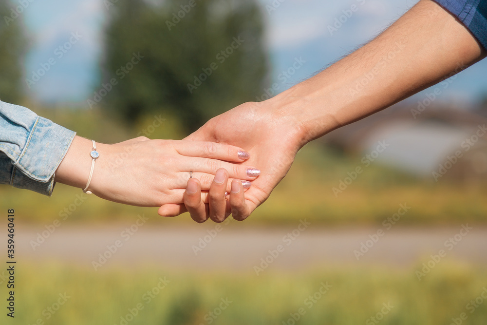 Lovers couple holding hands in a summer forest Lovers couple holding hands in a summer forest