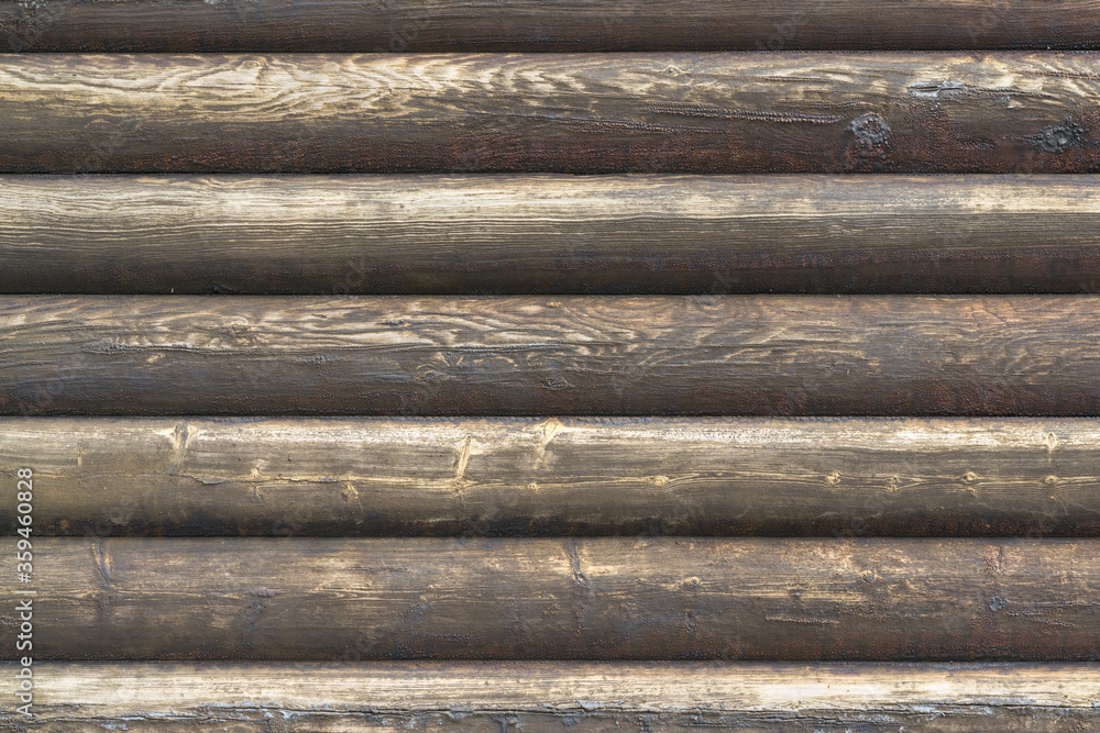 Natural brown log cabin wood wall. Wall texture background pattern. Natural brown log cabin wood wall. Wall texture background pattern.