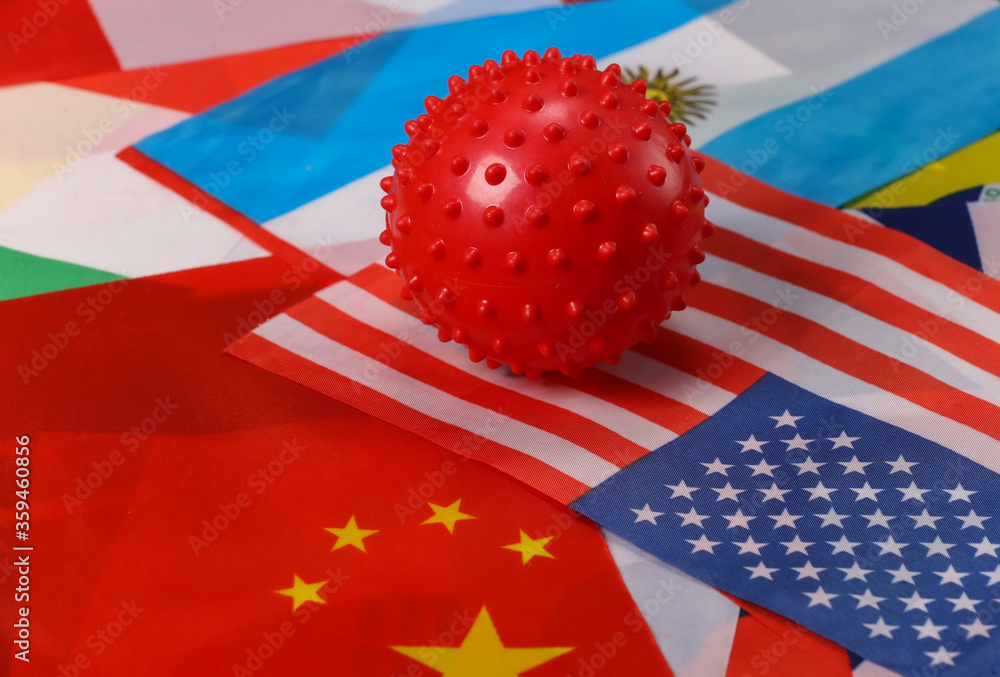 Covid-19 mock strain of the virus against the many flags of countries Covid-19 mock strain of the virus against the many flags of countries