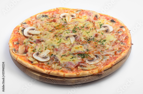 Ham monty pizza. Filed on a wooden board with a white background. Ingredients: mozzarella cheese, pesto sauce, herbs, ham, mushrooms.