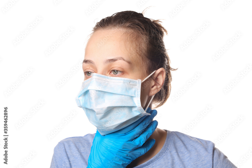 Symptoms of the flu. Woman in medical mask holds throat isolated on a white background. Sore throat.