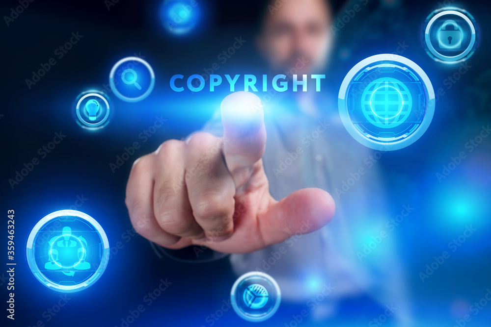 Business, Technology, Internet and network concept. Young businessman working on a virtual screen of the future and sees the inscription: Copyright Business, Technology, Internet and network concept. Young businessman working on a virtual screen of the future and sees the inscription: Copyright