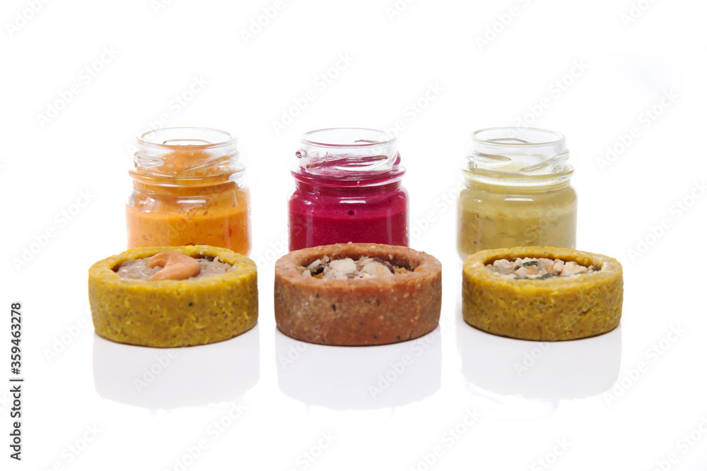 Nutrition concept - Healthy food, Diet, Detox, Clean Eating or Vegetarian concept. Glasses of food and small quiches. Nutritious food against white background. Nutrition concept - Healthy food, Diet, Detox, Clean Eating or Vegetarian concept. Glasses of food and small quiches. Nutritious food against white background.