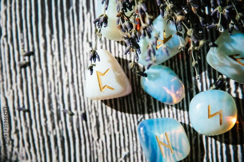 Fotografi Close up of rune stones on wooden table