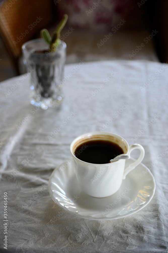 Black coffee in white cup with natural background, a simple idea photography.
