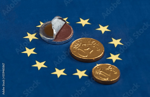 Chocolates in the shape of euro coins on Euro Union flag background