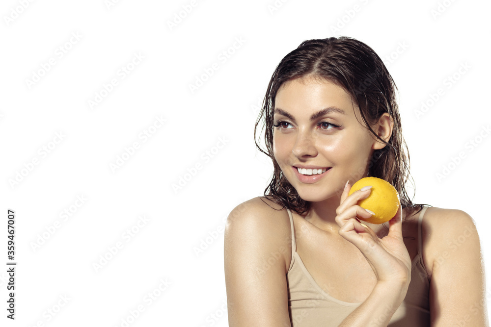 Fresh. Beautiful smiling young woman with lemon near face on white background. Concept of cosmetics, makeup, natural and eco treatment, skin care. Shiny and healthy skin, fashion, healthcare. Fresh. Beautiful smiling young woman with lemon near face on white background. Concept of cosmetics, makeup, natural and eco treatment, skin care. Shiny and healthy skin, fashion, healthcare.