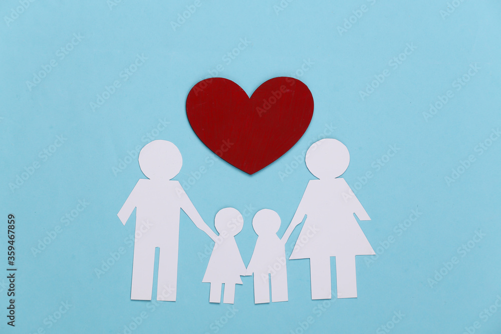 Paper happy family together with red heart on blue background Paper happy family together with red heart on blue background