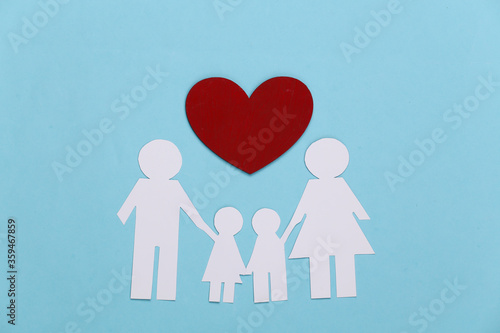 Paper happy family together with red heart on blue background