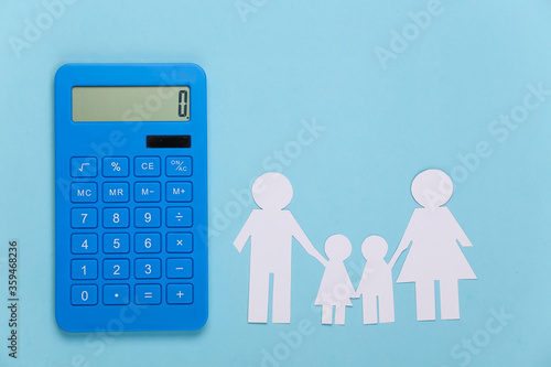 Obraz na plátně Paper happy family together with calculator on blue background