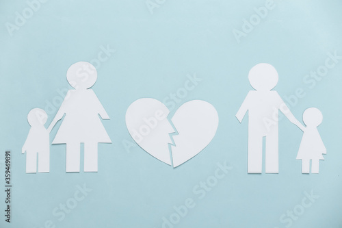 Broken family, divorce. Split paper family, broken heart on blue background