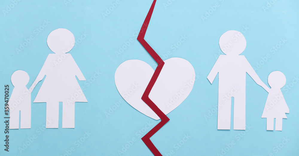 Broken family, divorce. Split paper family, broken heart on blue background Broken family, divorce. Split paper family, broken heart on blue background